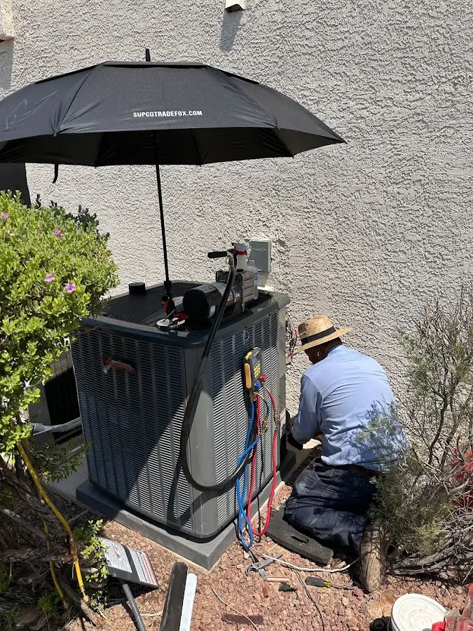 HVAC technician performing outdoor AC maintenance in Pleasant Valley