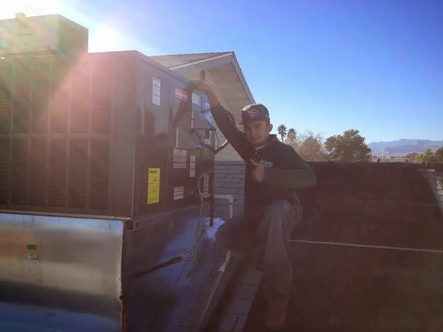 HVAC technician performing HVAC Inspection on a rooftop unit in Pleasant Valley
